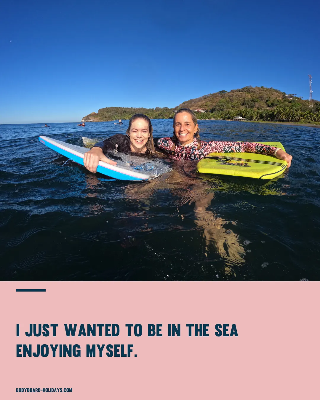 Two women in the sea holding bodyboards